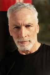 Obraz premium Vertical portrait of handsome positive caucasian senior man smiling camera
