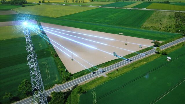 Aerial footage: radio signal from the cellular antenna is distributed to vehicles moving along the highway. Wireless Internet signal transmission system from a communication tower to vehicles. 4k 