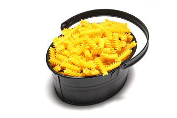 pile of spiral pasta scattered on light background. corkscrew shaped spiral pasta or fusilli pasta on white background