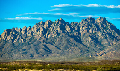 The rocky, sparsely vegetated Organ mountains rising above the central New Mexico desert.