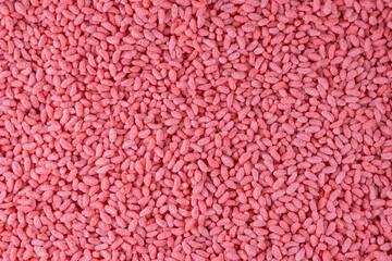 Strawberry flavored rice, corn and wheat cereal background. Crispy puffed pink rice. Delicious and...