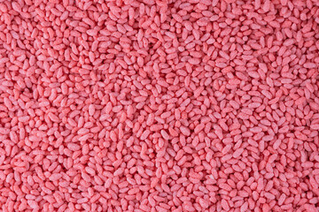 Strawberry flavored rice, corn and wheat cereal background. Crispy puffed pink rice. Delicious and nutritious strawberry-flavored