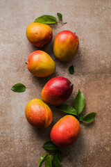 Mango background design concept. Top view of  fresh mango fruit pattern with leaves on  table.