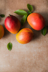 Mango background design concept. Top view of  fresh mango fruit pattern with leaves on  table.
