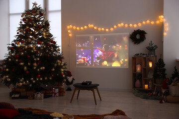 Video projector, Christmas tree, snacks, gifts and decorations in room