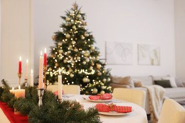 Fototapeta na wymiar Festive table setting and beautiful Christmas decor in room. Interior design