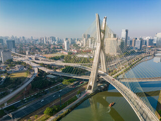 Obraz na płótnie Canvas 2023 view of the Pinheiros river with modern buildings beside it and the famous Octavio Frias de Oliveira bridge in the city of São Paulo.