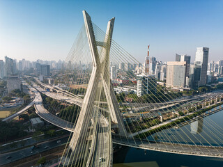 Fototapeta na wymiar 2023 view of the Pinheiros river with modern buildings beside it and the famous Octavio Frias de Oliveira bridge in the city of São Paulo.
