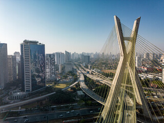 Fototapeta na wymiar 2023 view of the Pinheiros river with modern buildings beside it and the famous Octavio Frias de Oliveira bridge in the city of São Paulo.