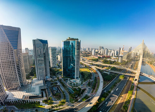 2023 view of the Pinheiros river with modern buildings beside it and the famous Octavio Frias de Oliveira bridge in the city of S&atilde;o Paulo.