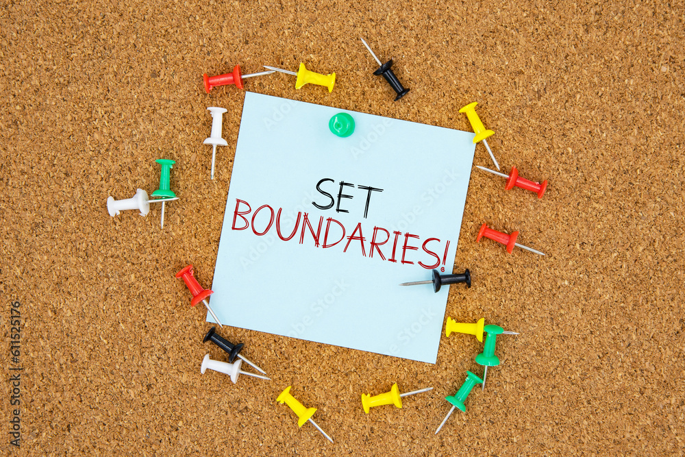 Poster set boundaries text on light blue post-it paper pinned on bulletin cork board surrounding by multi c