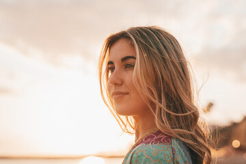 Portrait of one young woman at the beach looking at the sea enjoying free time and freedom...