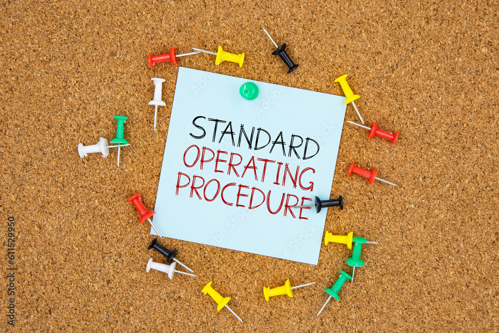 Poster standard operating procedure text on light blue post-it paper pinned on bulletin cork board surround