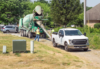 Workers Rinsing Cement Truck Chute During Drought - obrazy, fototapety, plakaty