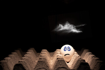 Egg with a scared or stressed face with a cloud over it.