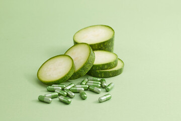 Against the green background, fresh slices of winter melon with green capsules arranged. Winter...