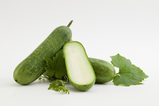 Against a white background, fresh winter melon and green leaf isolated. Winter melon contains a high amount of vegetable oil, which is very beneficial for skin and hair