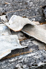 A pile of asbestos removed from an old roof. Hazardous waste prepared for disposal.
