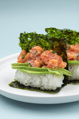 Portion of japanese hand rolls with salmon and avocado