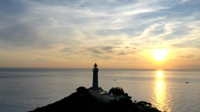 Dai Lanh Lighthouse light on the stone shore. The powerful lighthouse illuminated. Phu Yen, Vietnam