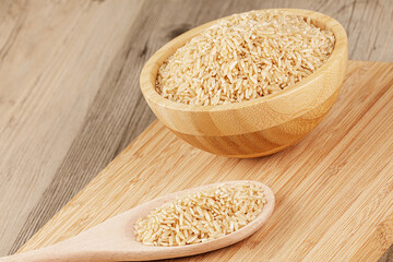 Close up of a wooden bowl of delicious uncooked Brown Rice
