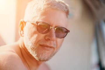 Outdoor portrait of mid aged happy caucasian man in sunglasses l