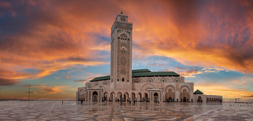Low angle view of historic Mosque Hasan II with tallest minaret against dramatic sky - obrazy, fototapety, plakaty