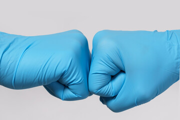 Two medical workers making a fist bump gesture.