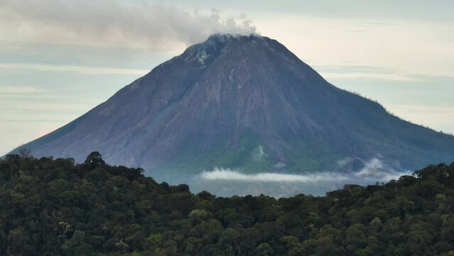 Mountains with tropical forest and Mount Sinabung. Sumatra, Indonesia.
