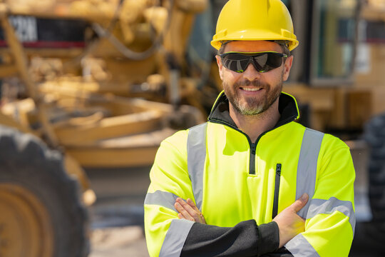 Construction man with helmet. Worker at construction new building. Builder at construction site. Foreman workman portrait. Builder in helmet outdoor portrait. Worker in hardhat.