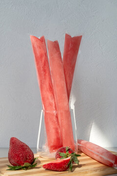 Ice cream in a bag with strawberries, sweet frozen homemade. Brazilian Dindin, geladinho or Sokole.