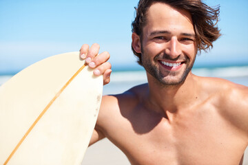Portrait, surfing and a man in the ocean at the beach for surfing while on summer holiday or...
