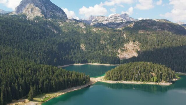 Aerial view of Black Lake in Durmitor National Park, Montenegro. Mountain lake Crno Jezero in Zabljak is attraction of Monenegro. Sunny summer day.