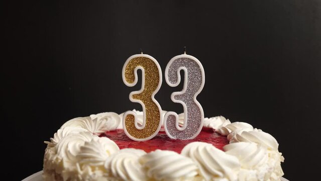 A candle in the form of the number 33, inserted into the holiday cake, is blown out. Celebrating a birthday or a landmark event. The climax of the celebration.