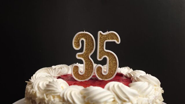 A candle in the form of the number 35, inserted into the holiday cake, is blown out. Celebrating a birthday or a landmark event. The climax of the celebration.