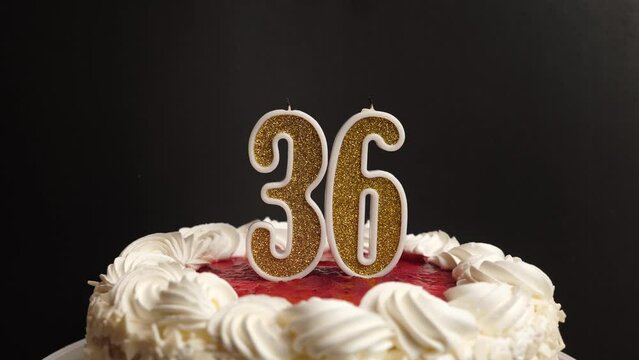 A candle in the form of the number 36, inserted into the holiday cake, is blown out. Celebrating a birthday or a landmark event. The climax of the celebration.