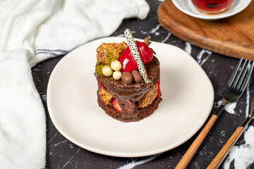 Chocolate, Strawberry and Pistachio Cake. Delicious cake on dark background