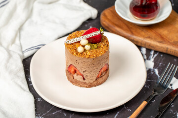 Strawberry, Croquant and Pistachio Cake. Delicious cream cake on dark background