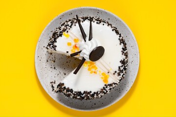 Delicious cake onon plate. Lunch at work. Copy space. Yellow background