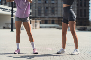 Fototapeta premium Cropped photo of two fit sportsgirls