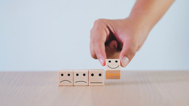 satisfaction survey concept hand picking smiley faces on wooden block 5 Star Satisfaction Customer Service The best scoring experience