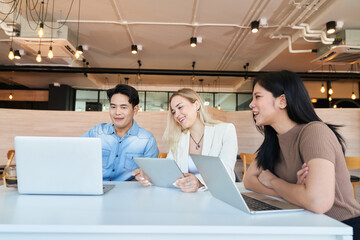 Diverse team male and female working together and happy face in business co working space.