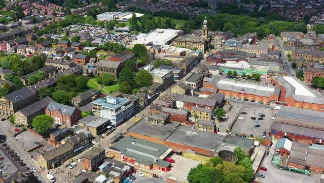 Aerial drone footage of the town of Morley in Leeds West Yorkshire, England showing the beautiful British town main street and housing estates from above on a sunny summers day.