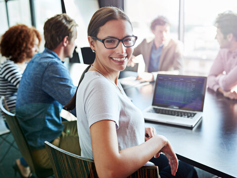 Smile, portrait and a woman in a meeting with a laptop for planning, teamwork or work agenda. Happy, corporate and lawyers in a boardroom for business training, workshop or seminar together in office