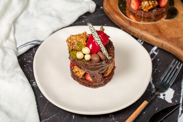 Chocolate, Strawberry and Pistachio Cake. Delicious cake on dark background