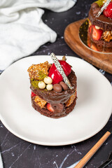 Chocolate, Strawberry and Pistachio Cake. Delicious cake on dark background