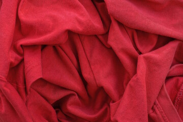 red texture from a piece of crumpled fabric on old clothes