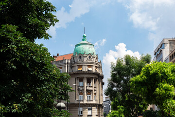 Part of a classical building in Belgrade. A building with a rotunda on the corner. - obrazy, fototapety, plakaty
