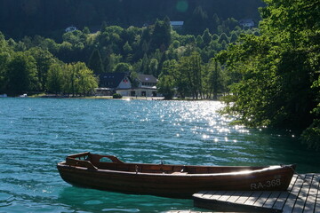 The wooden rowing boat on shimmering water in the sunshine. Slovenia Lake Bled - May 26.2017