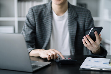 Male doing finance at home office with calculate expenses.